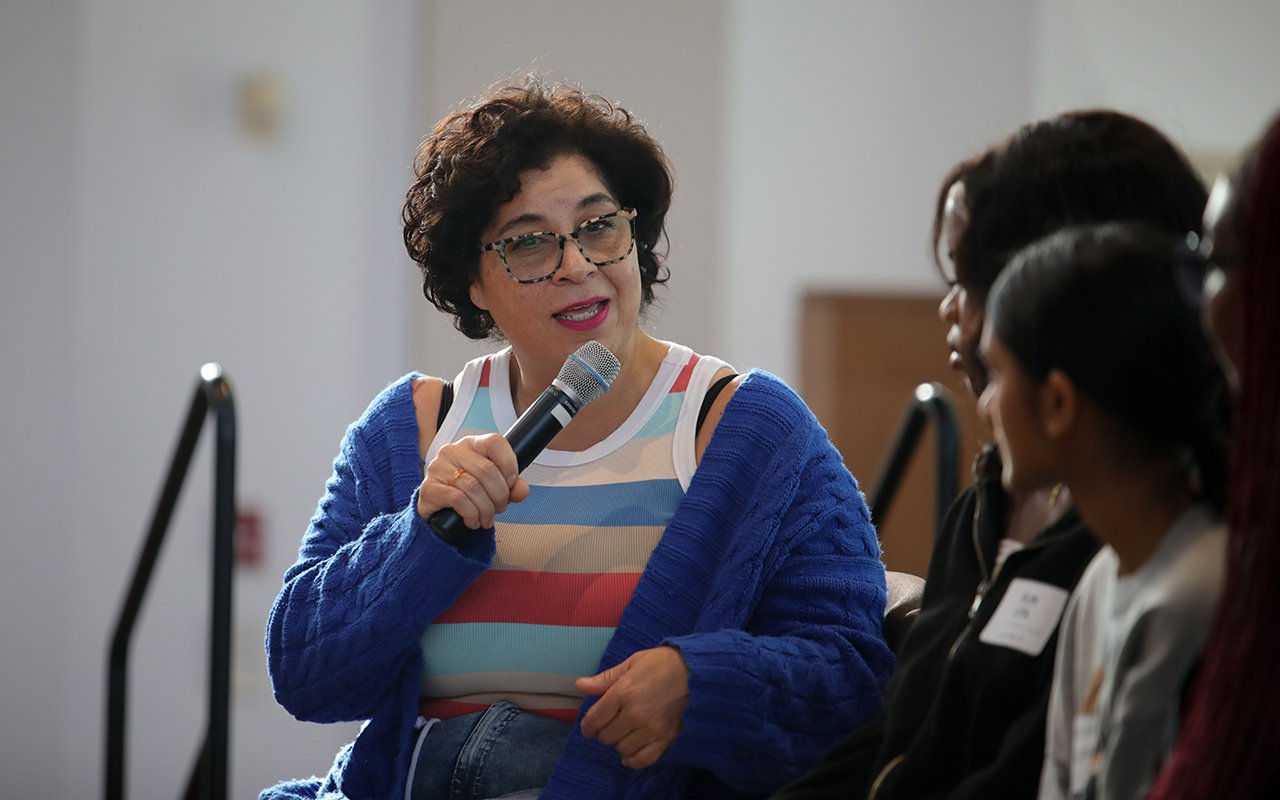 A moderator asks students questions during the State of the Student Conference