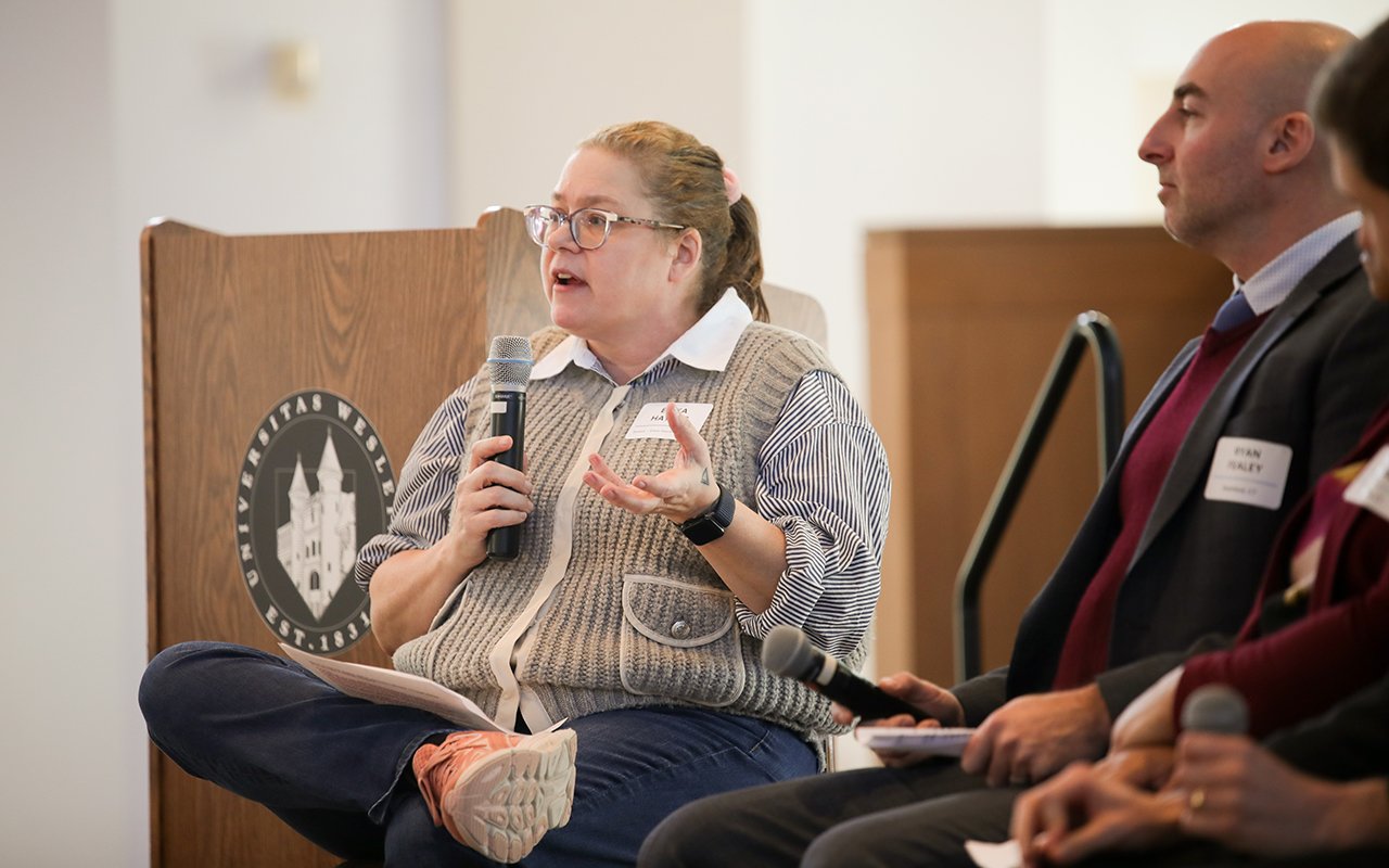 A moderator speaks during a session at the State of the Student Conference