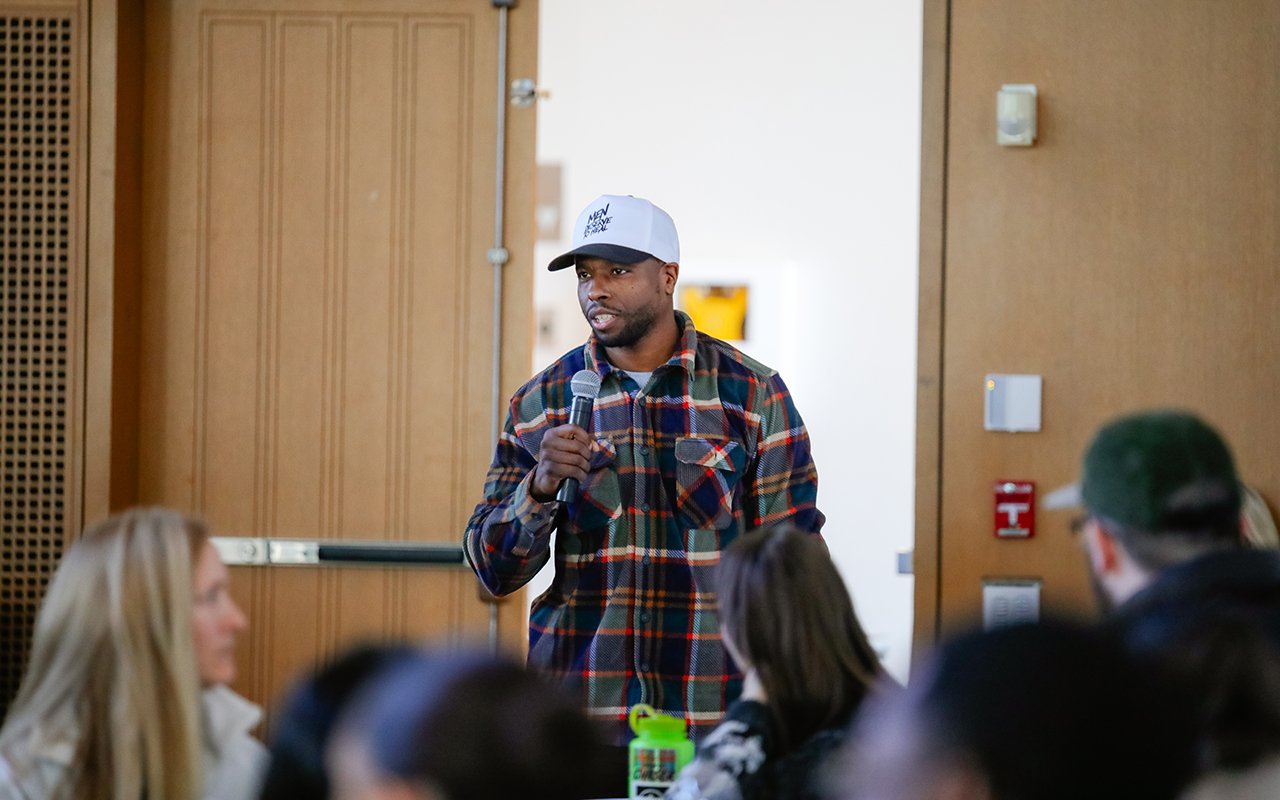 A speaker stands up during the State of the Student Conference