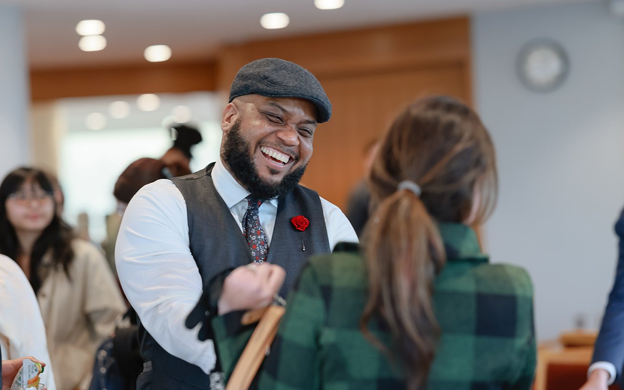 Kevin Booker Jr. chats with a conference attendee at the 2025 State of the Student Conference