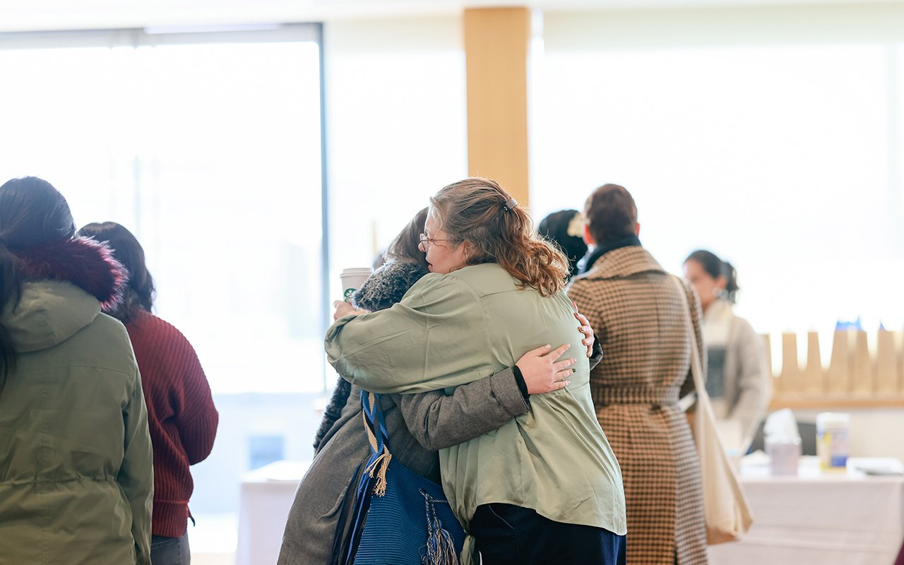 Erika Haynes hugs an attendee during the 2025 State of the Student Conference