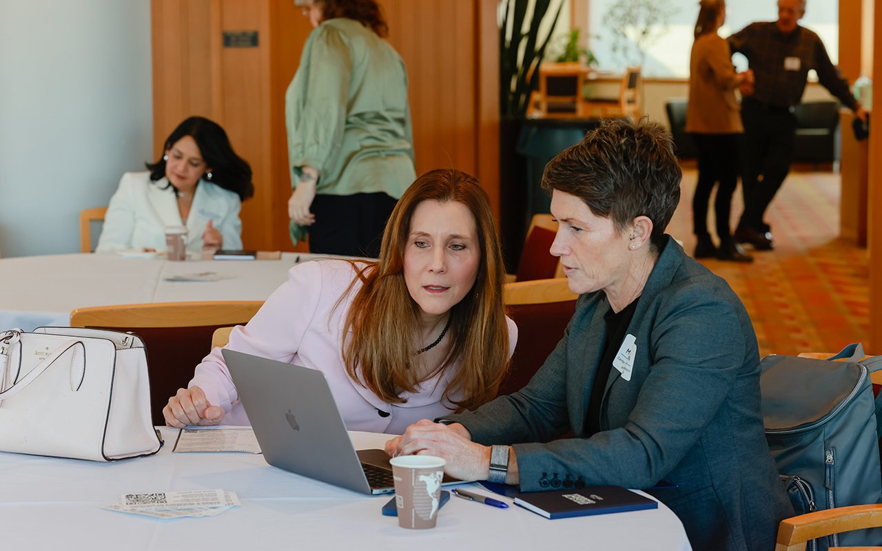 Two attendees chat during the 2025 State of the Student Conference